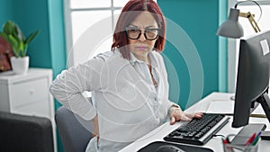 Middle age woman business worker suffering for backache working at the office