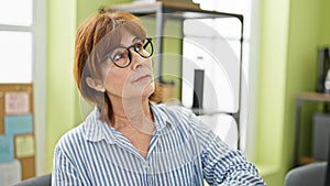 Middle age woman business worker thinking at office