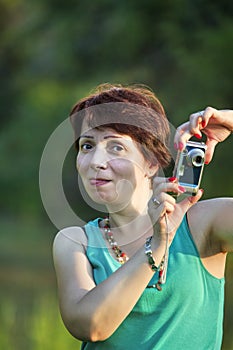 middle age woman in the city playing silly photographer