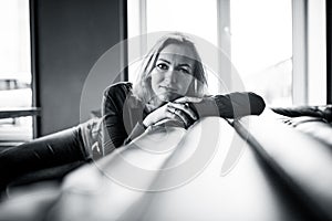 Middle age woman in a coffe shop Background, model.