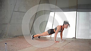 Middle age woman doing push up exercises outdoor