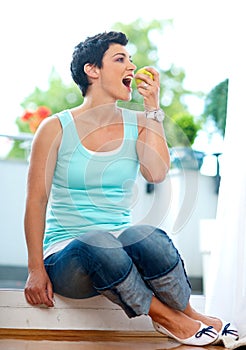 Middle age woman eating apple