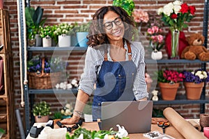 Middle age woman florist smiling confident standing at flower shop