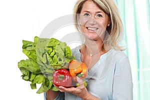 Middle age woman with healthy vegetables