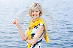 Middle age woman outdoors gesturing thumb up