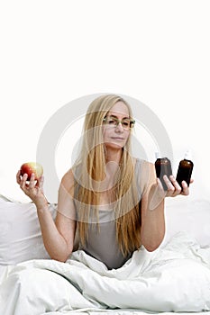 Middle age woman real portrait bed bedroom blonde long hair fifty plus copy space 50 blanket pillow face glasses medical assistanc