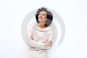 Middle age woman smiling with arms crossed against white background