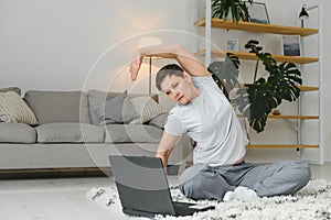 Middle age woman smiling happy doing exercise and stretching at home