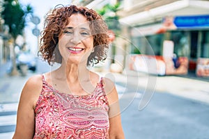 Middle age woman smiling happy walking at street of city