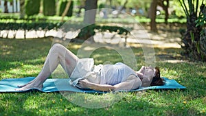 Middle age woman training abs exercise at park