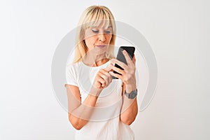 Middle age woman using smartphone standing over isolated white background with a confident expression on smart face thinking