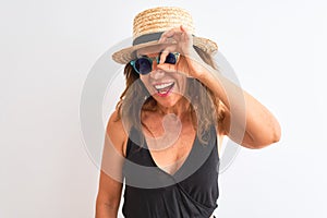 Middle age woman wearing black t-shirt sunglasses and hat over isolated white background with happy face smiling doing ok sign