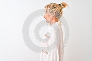 Middle age woman wearing casual shirt standing over isolated white background looking to side, relax profile pose with natural