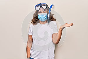 Middle age woman wearing coronavirus protection mask and diving gogles glasses as canceled vacation celebrating achievement with