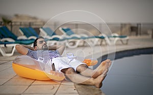 Middle aged arab man by a pool