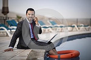 Middle aged arab man by a pool in his business suit