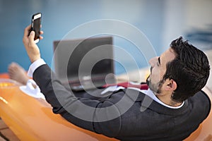 Middle aged arab man by a pool in his business suit