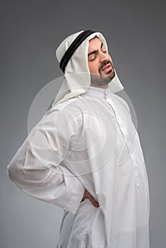 Middle aged Arab touching his aching waist