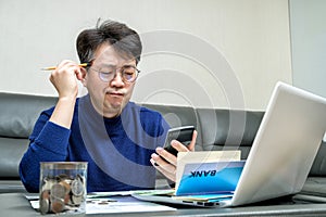 Middle-aged Asian man preparing for tax return