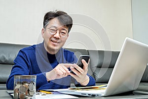 Middle-aged Asian man preparing for tax return