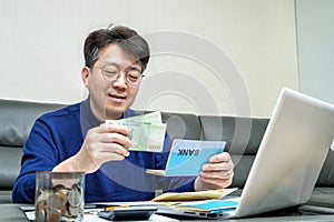 Middle-aged Asian man preparing for tax return.