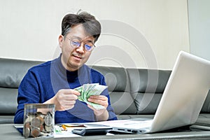 Middle-aged Asian man preparing for tax return.