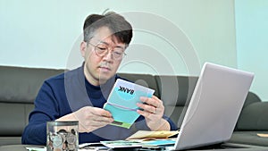 Middle-aged Asian man preparing for tax return.