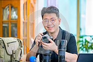 A middle-aged Asian man whose hobby is 35mm/135mm film SLR camera