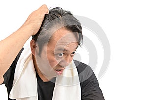 Middle-aged asian man worry about his  hair loss