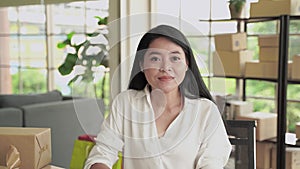 A middle-aged Asian woman is greeting through video calls, She listened intently.