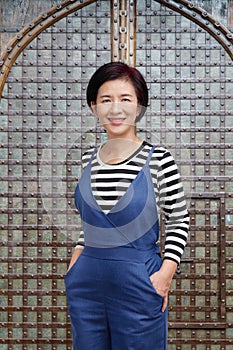 Middle aged asian woman smiling in casual clothes