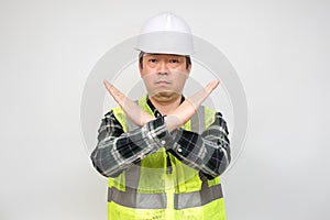 A middle-aged Asian worker who raises his hand and expresses his disapproval