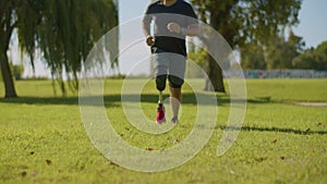 Middle-aged athlete with leg prosthesis jogging in city park.