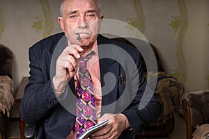 Middle Aged Bald Businessman Holding Pen and Notes