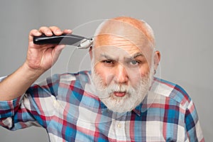 Middle aged bald man hair clipper, Mature baldness and hair loss concept.