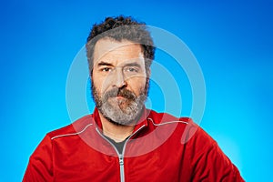 Middle aged bearded man portrait on blue background