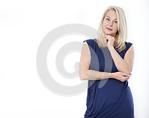 Middle-aged beautiful woman looking up thinking and dreaming isolated on white background