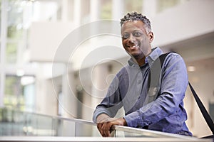 Middle aged black man smiling in modern building lobby