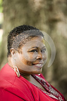 Middle-aged Black woman outdoor portrait red top