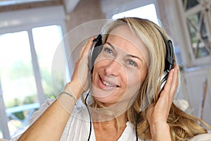 Middle-aged blond woman with headphones