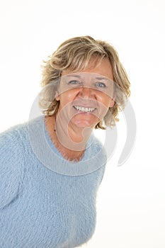 Middle aged blonde beautiful happiness smile senior woman looking confident in blue sweater on white background