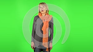 Middle aged blonde woman with shocked wow face expression. Green screen