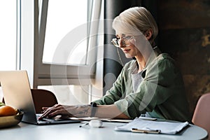 Middle aged blonde woman with short hair studying