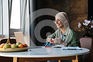 Middle aged blonde woman with short hair studying