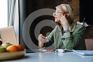 Middle aged blonde woman with short hair studying