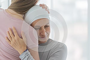 A middle-aged breast cancer woman hug and cuddle her daughter with happy and trust in her support