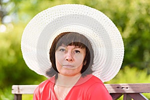 A middle-aged brunette white hat