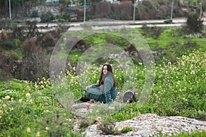 Middle-aged brunette woman on the background of beautiful nature