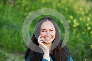 Middle-aged brunette woman on the background of beautiful nature