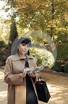 Middle-aged business woman talking on smartphone wearing fashionable fall outdoors
